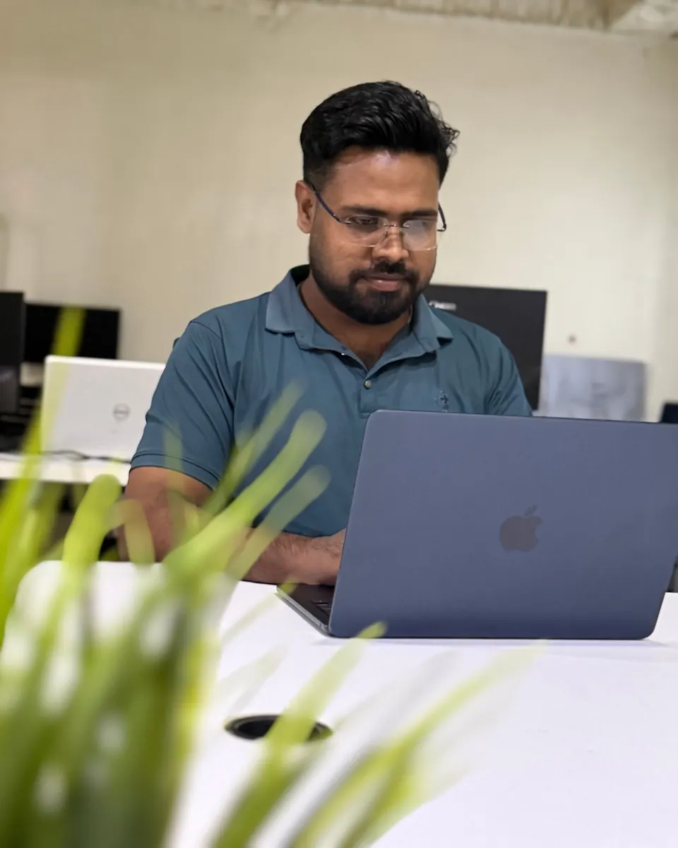 KMR Jibon working on a laptop at a desk in the Softvole office
